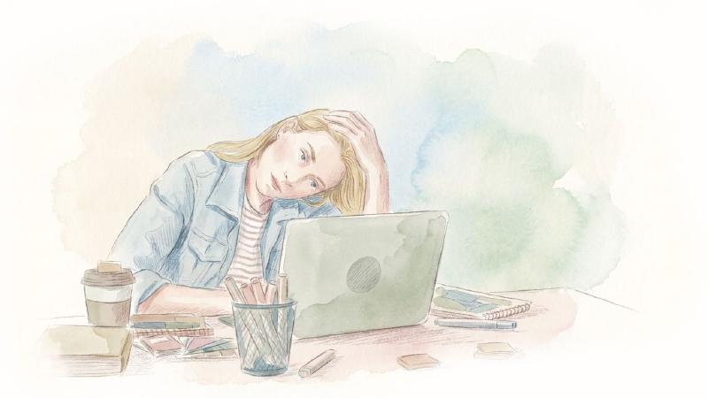A woman appears stressed while working on laptop.